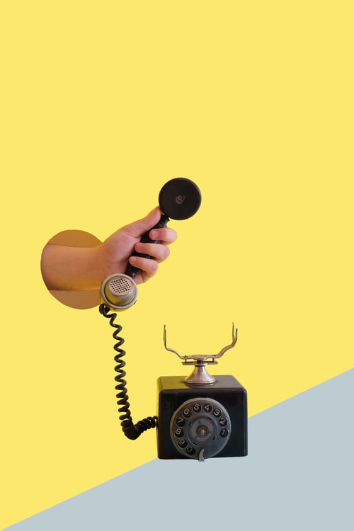 A graphic of a salesperson holding an old fashioned telephone to symbolise earlier steps in lead generation
