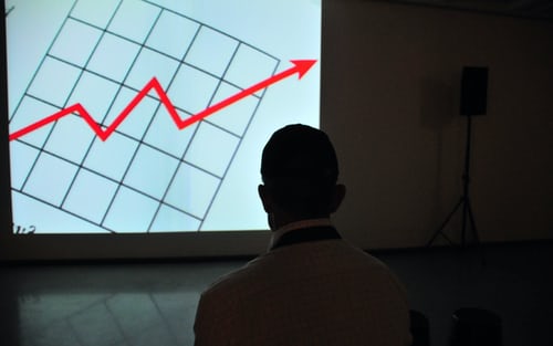 A man presenting a sales chart through screen sharing