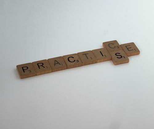 Practice spelled out in scrabble pieces against a white background