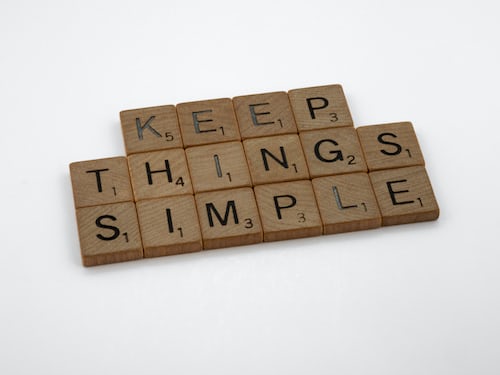 Keep things simple spelled out in scrabble pieces against a white background