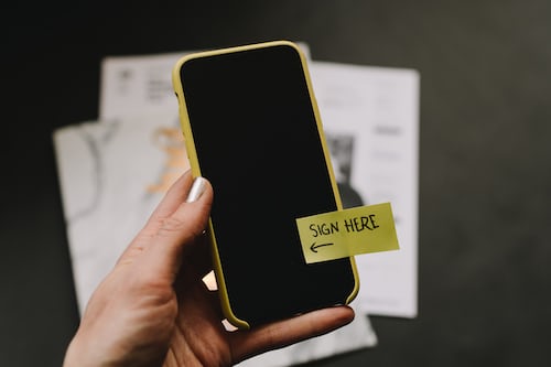 A smartphone with a sign here option enabling customers to complete documents