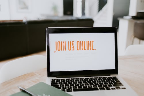 A laptop inviting users to join them online for a sales webinar