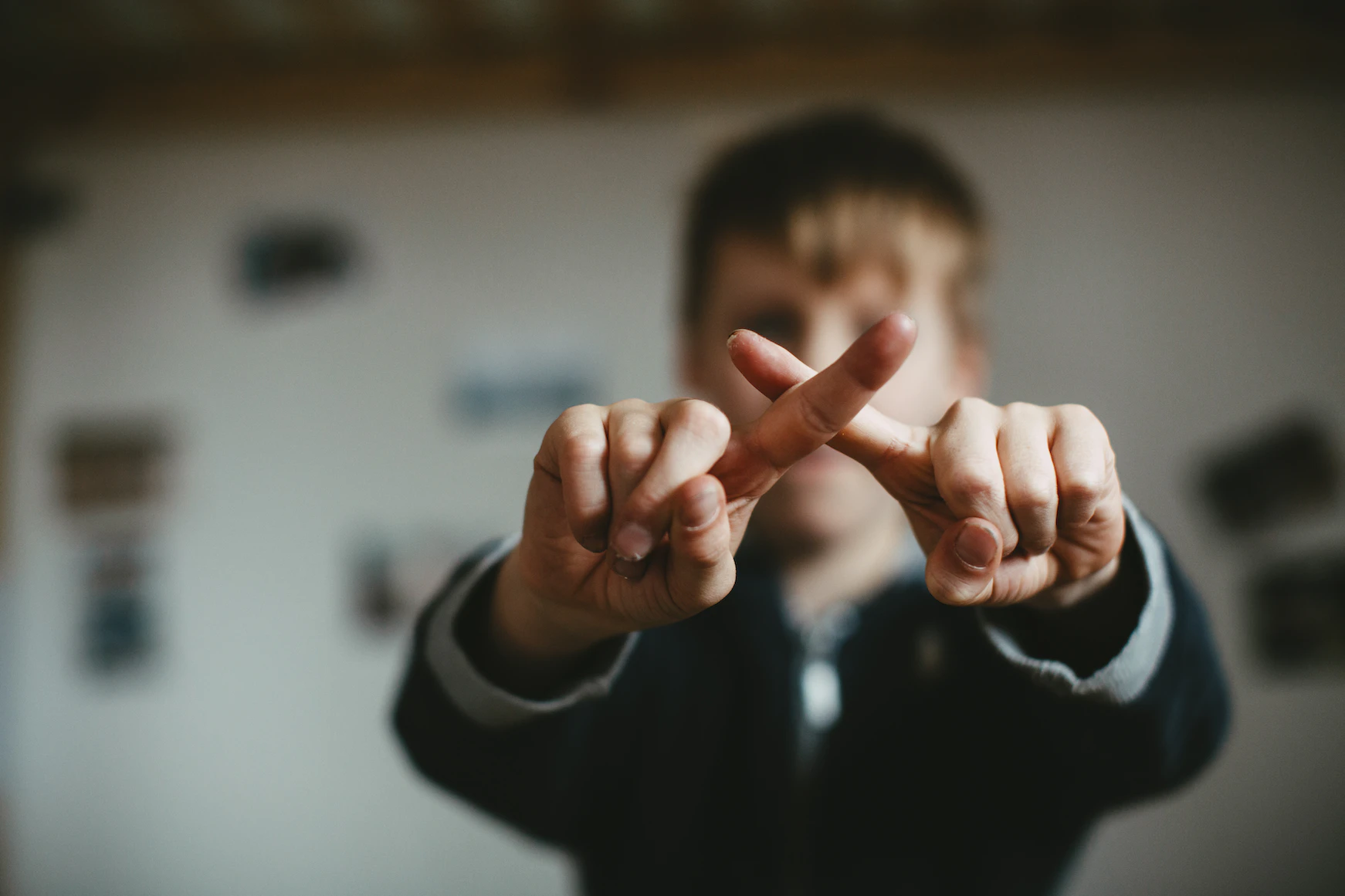 A virtual salesperson making a cross with their hands