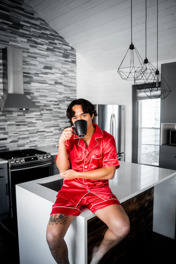 A virtual salesperson having a coffee in their pyjamas in the kitchen